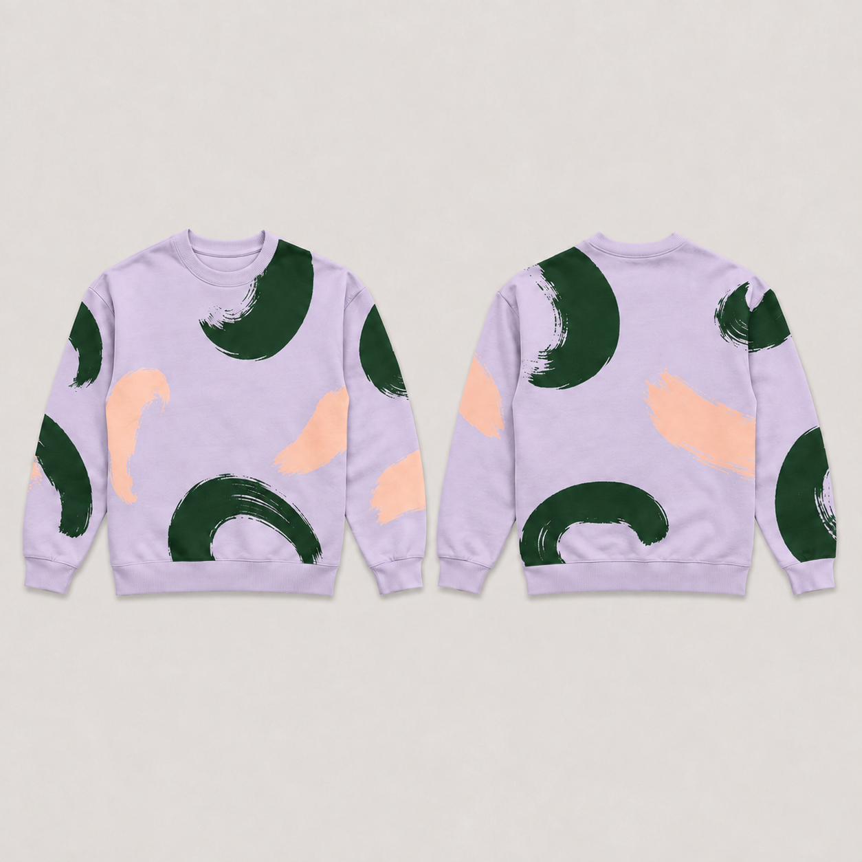 Front and back of a lilac crewneck sweatshirt with large open forest-green brush crescents and peach counterstrokes, and plain lilac neck, cuffs and hem.