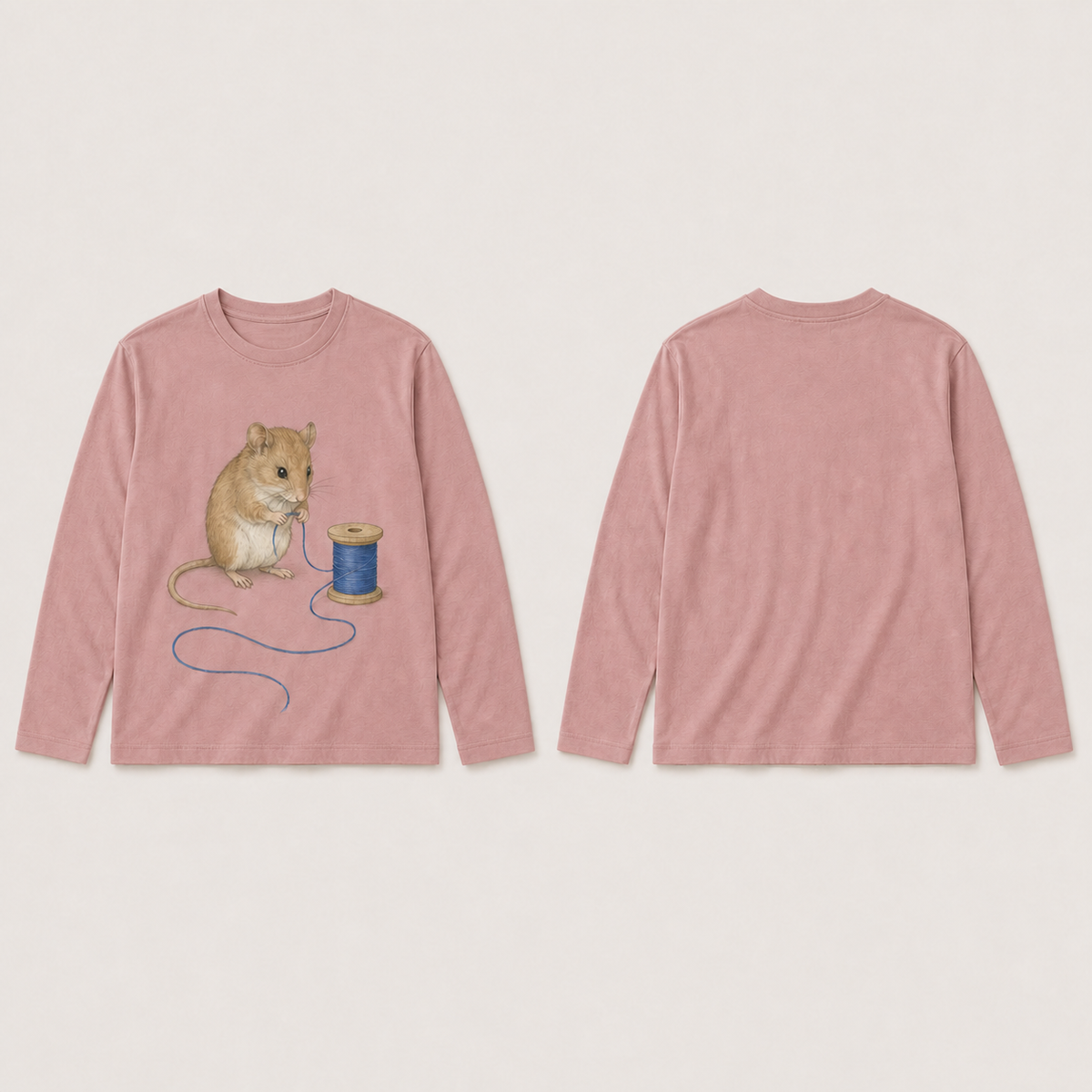 Front and back of a muted-rose long-sleeve tee with a mouse, wooden spool and loose blue thread on the front and a plain back.