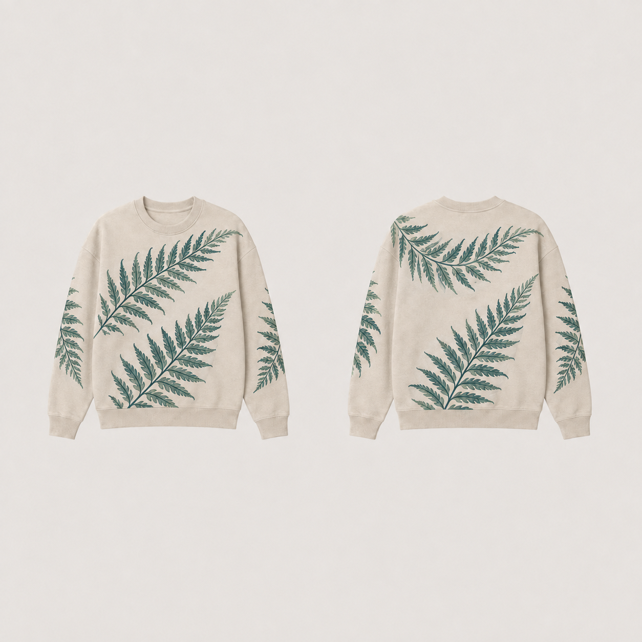 Front and back of an oat crewneck with large dark-teal and sage fern-like fronds and plain oat ribs.
