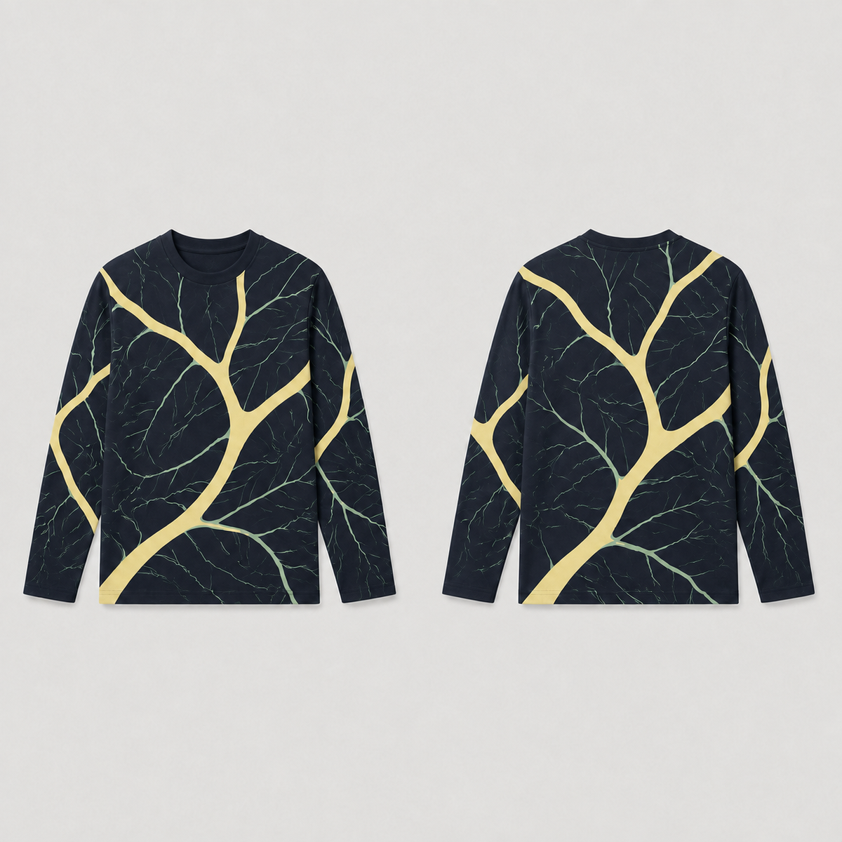 Front and back of an ink long-sleeve tee with curving butter-colored branches and finer celadon veins.