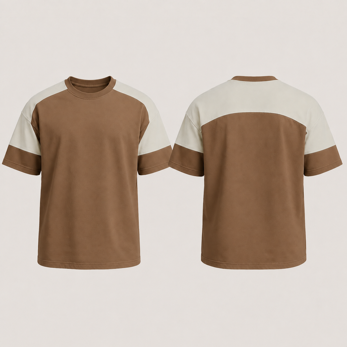 Front and back of a tobacco tee with the same continuous shoulder-spanning saddle in pale stone.