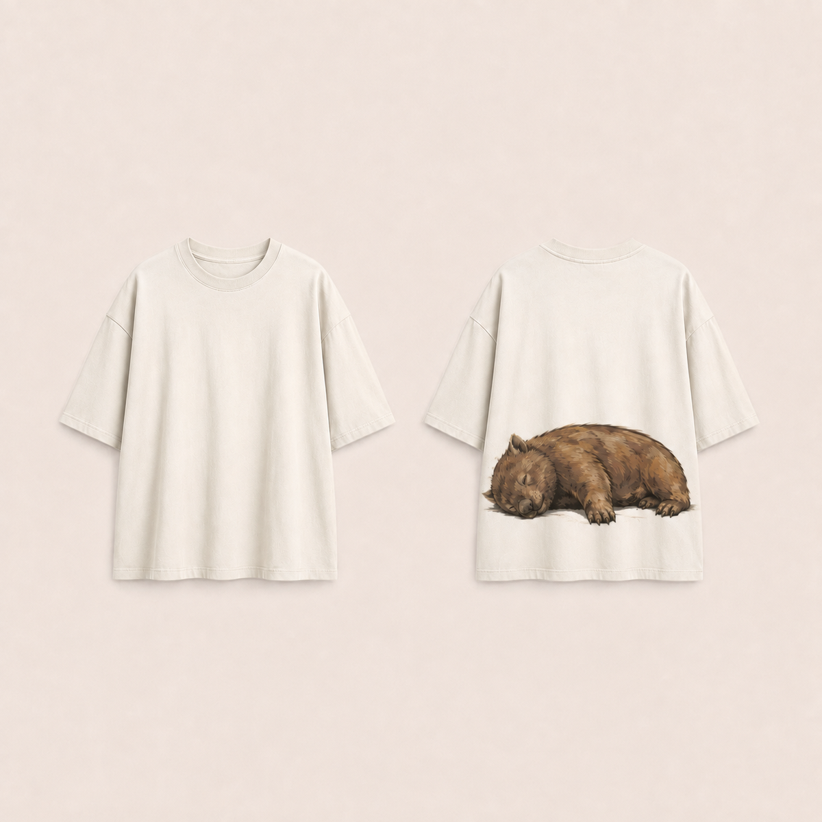 Front and back concept views of the same oversized tee in warm chalk, preserving the ochre resting-wombat back illustration.