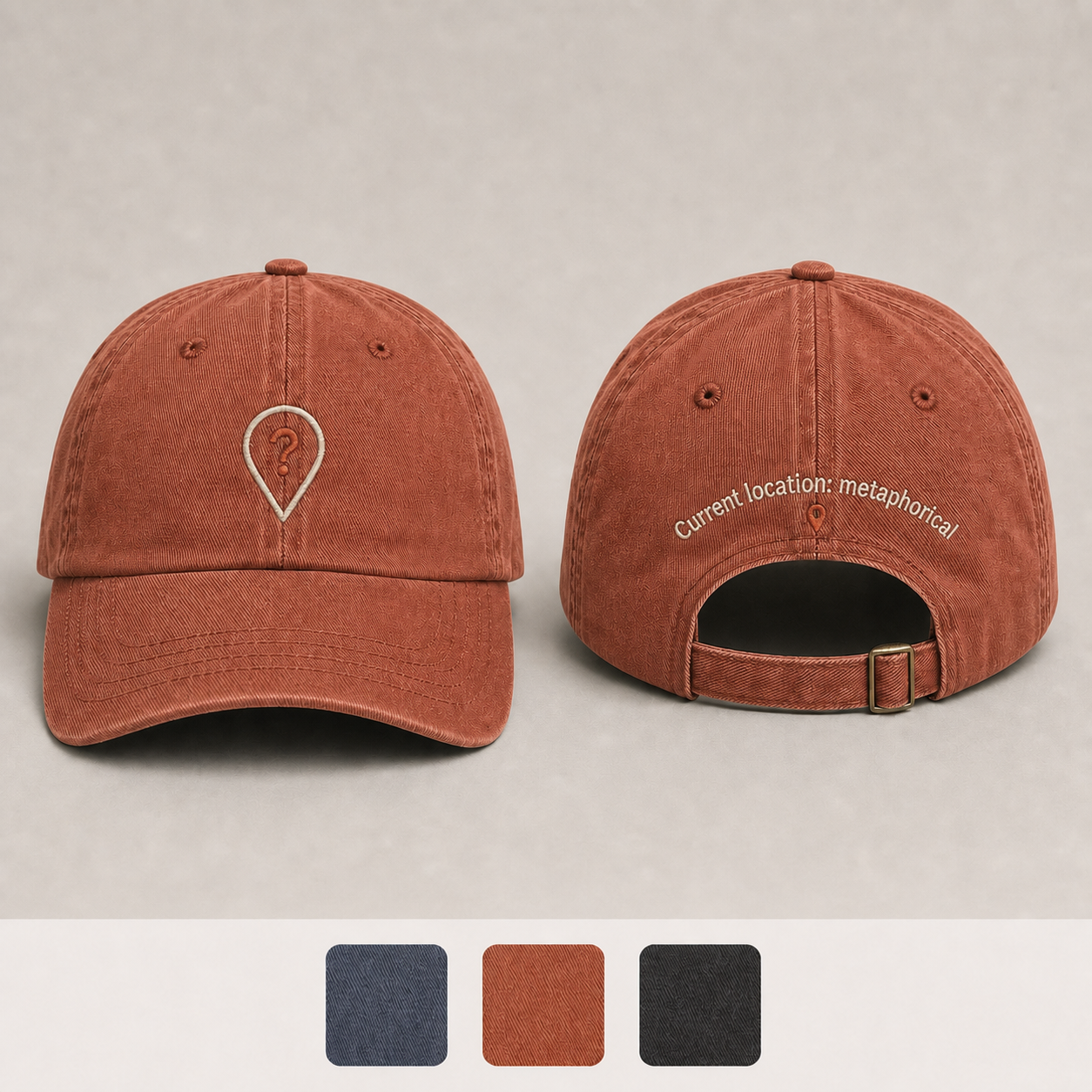 Faded Rust Color. Front and back of a slate-blue low-profile cap with a question-mark location pin and the phrase Current location: metaphorical.
