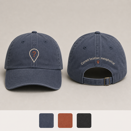 Slate Blue Color. Front and back of a slate-blue low-profile cap with a question-mark location pin and the phrase Current location: metaphorical.