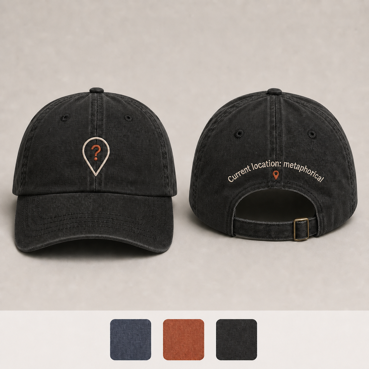 Washed Black Color. Front and back of a slate-blue low-profile cap with a question-mark location pin and the phrase Current location: metaphorical.