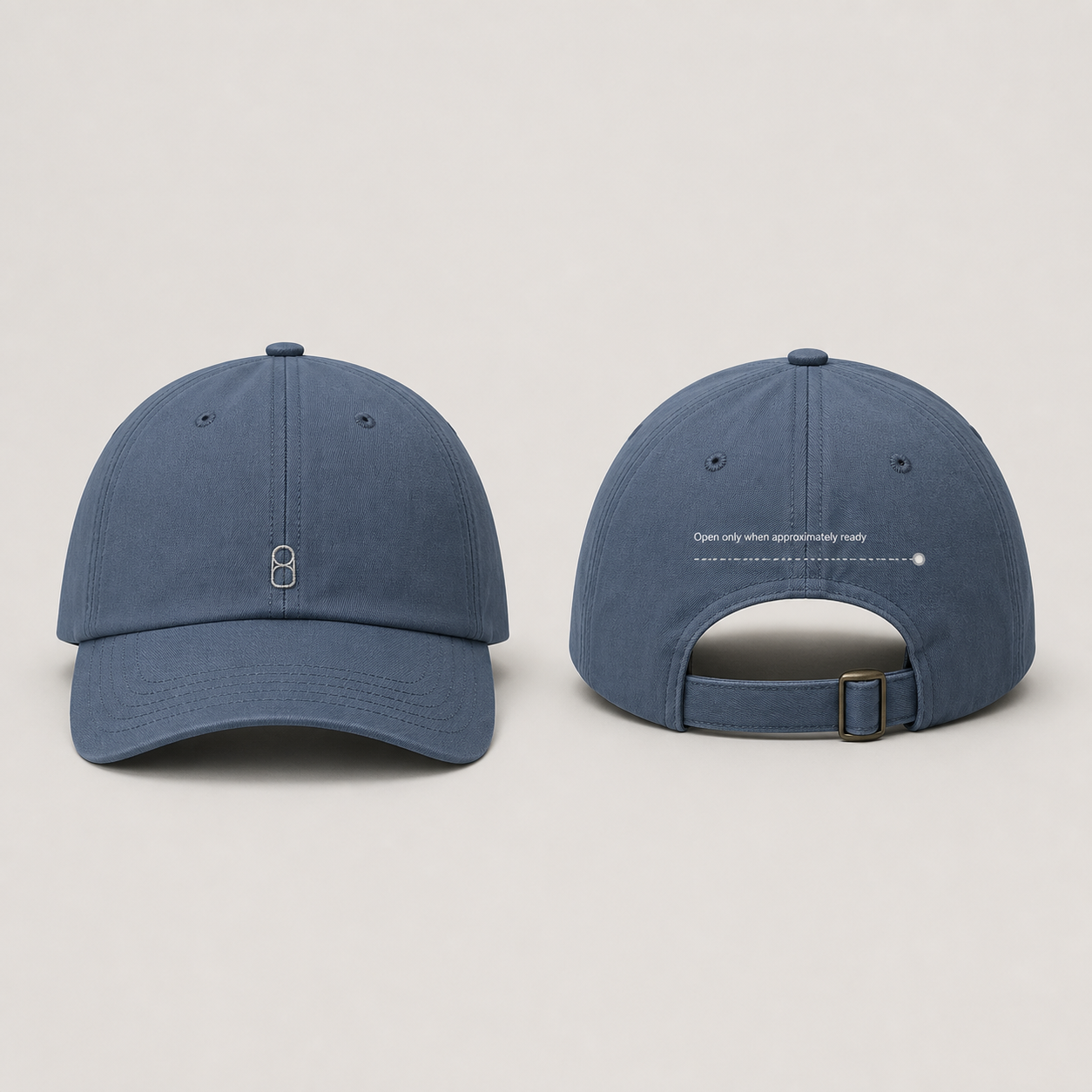 Front and back of a slate-blue low-profile cap with a tiny pull-tab icon and a perforated seal ending near the rear closure.