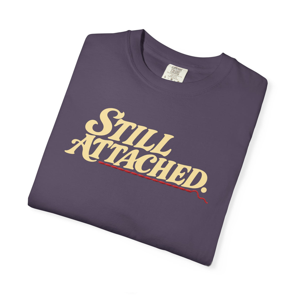 Supplier-generated Still Attached Tee mockup 3: Wine Comfort Colors 1717 with the current front and back artwork placement.