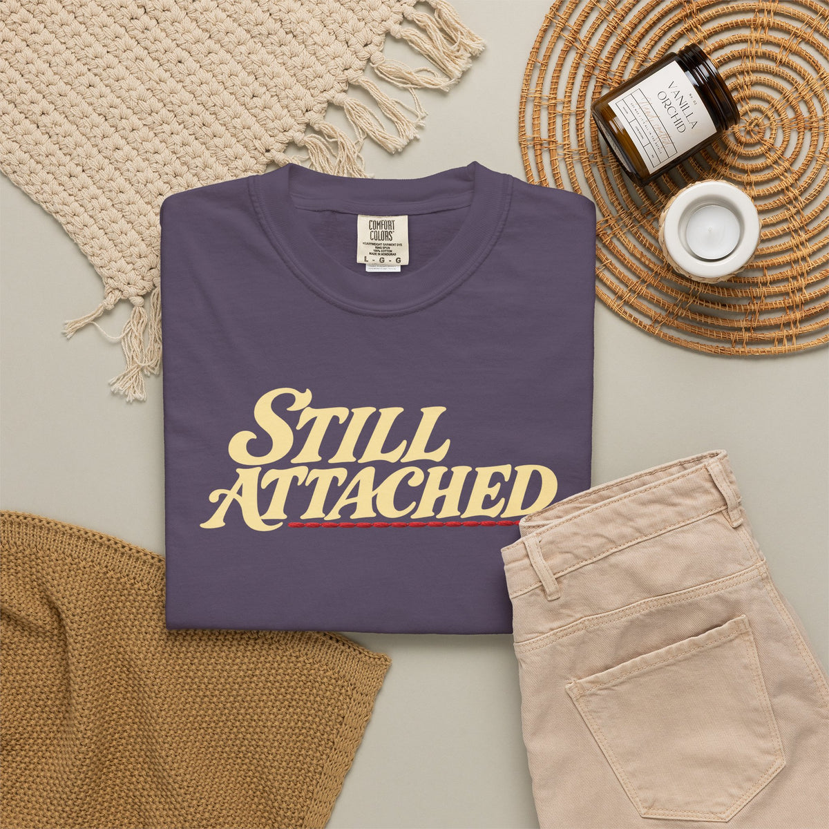 Supplier-generated Still Attached Tee mockup 4: Wine Comfort Colors 1717 with the current front and back artwork placement.
