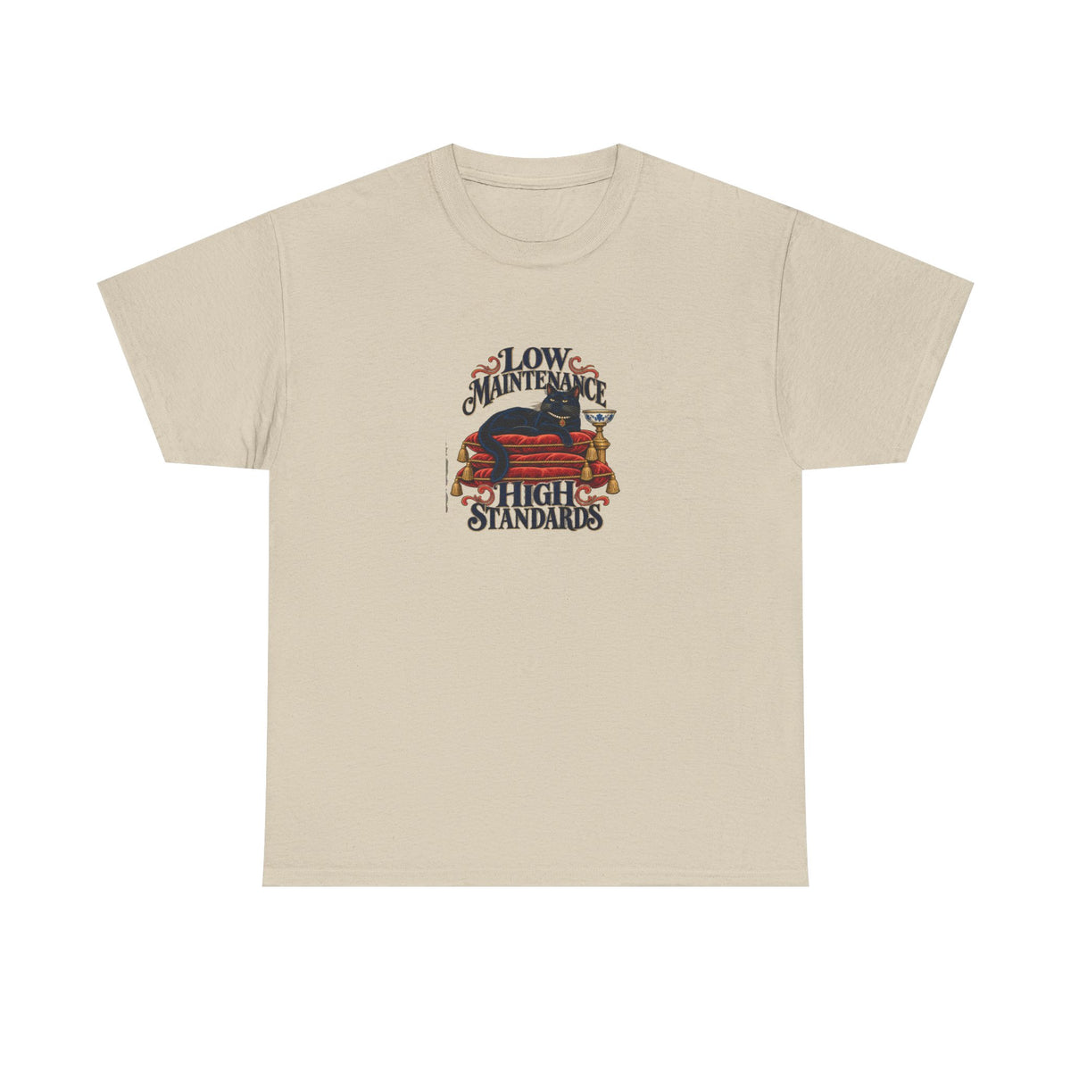Sand Low Maintenance Tee, front view with black cat reclining on red cushions and “LOW MAINTENANCE HIGH STANDARDS” graphic.