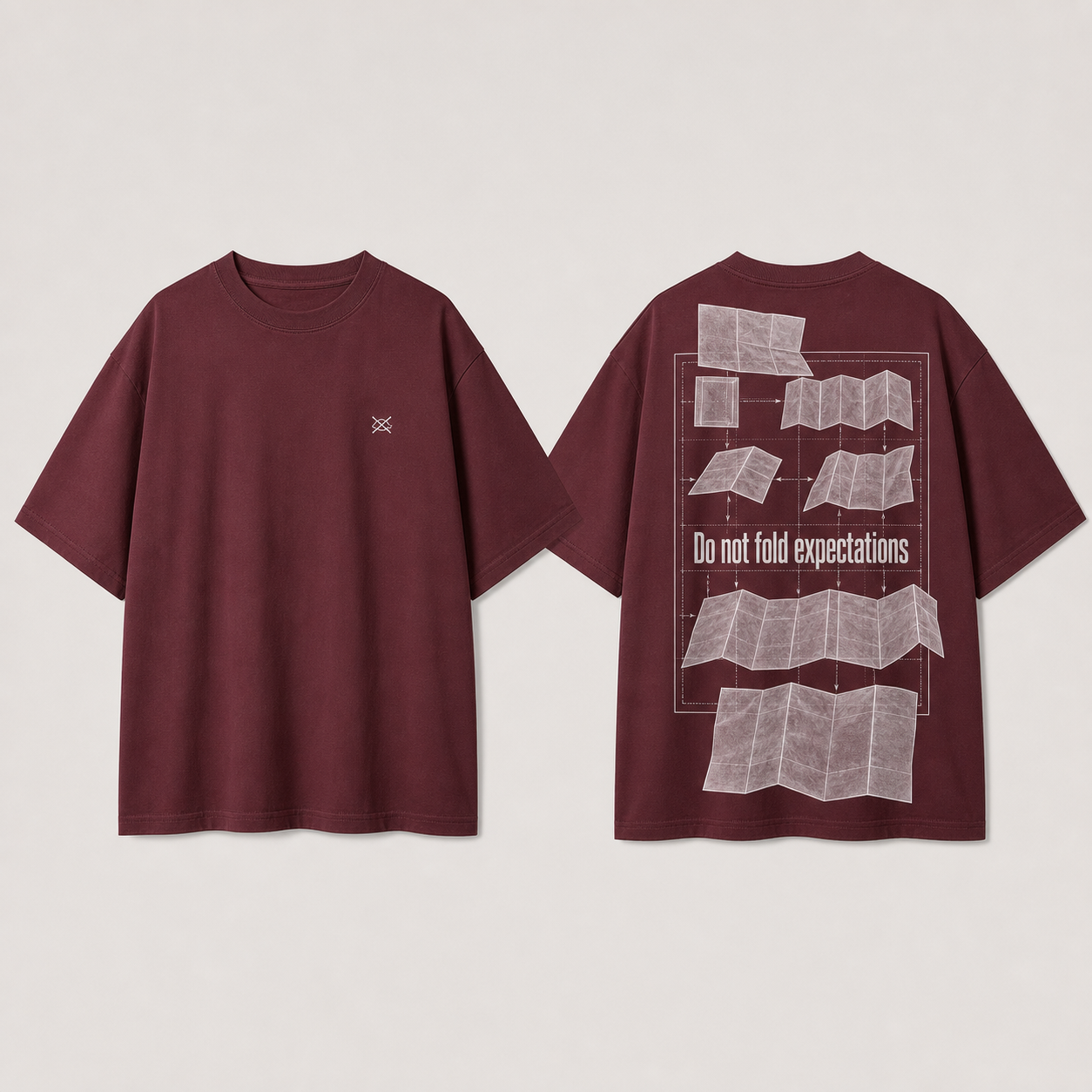 Front and back of an oxblood heavyweight tee with a crossed fold icon and expectation cards unfolding beyond an instruction grid.