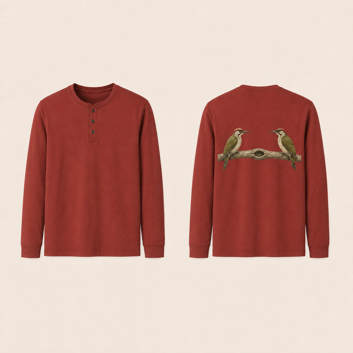 Front and back of a clay-red Henley long-sleeve tee with a three-button placket; two natural woodpeckers face inward on a branch with a hollow knot on the back.