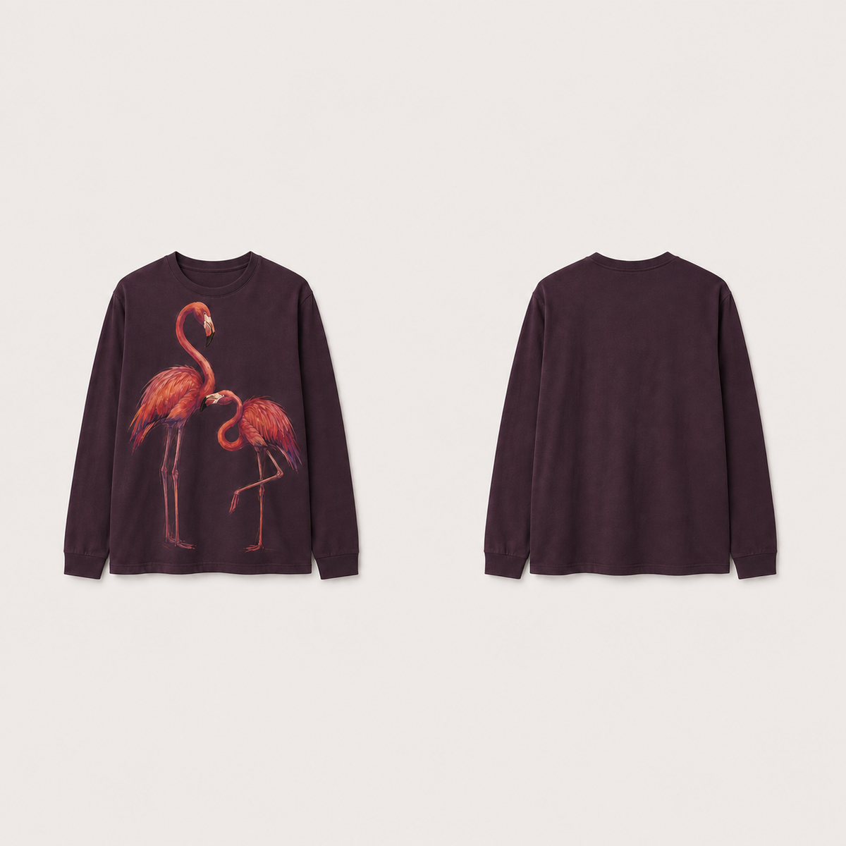Front and back of an ink-plum long-sleeve tee with two coral flamingos in an asymmetric pose on the front and a plain back.