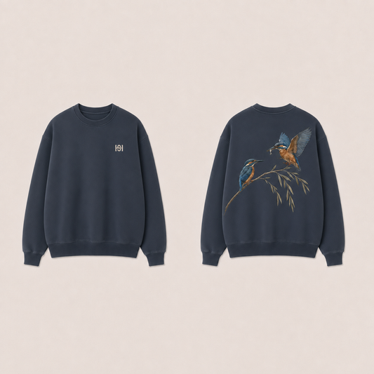 Front and back of a faded navy crewneck, with a small pale HELLOH symbol on the wearer-left chest and two kingfishers on a willow branch, one landing with a fish, on the back.