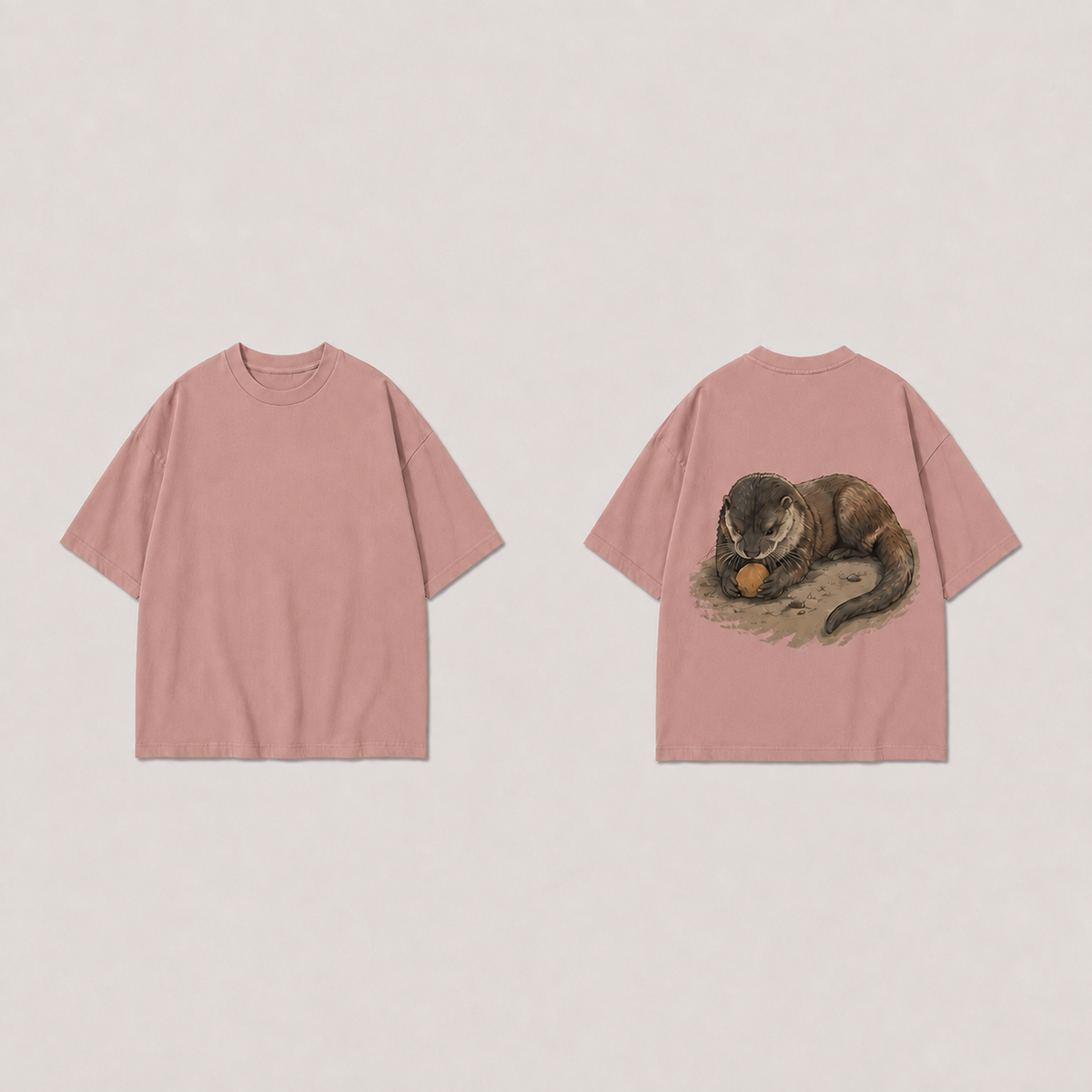Front and back of a tea rose oversized tee, plain on the front, with one otter holding an ochre stone between its forepaws on the back.
