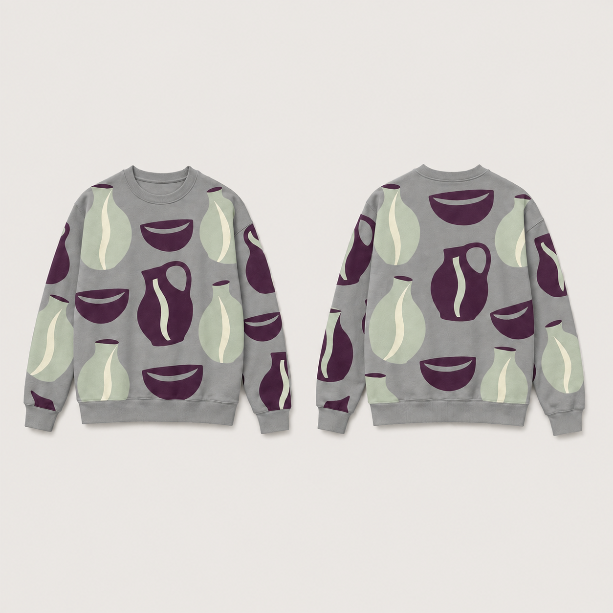 Front and back of a smoke-grey crewneck patterned with plum bowls and handled jugs and pale-celadon vessels; neckline, cuffs and hem are plain grey.