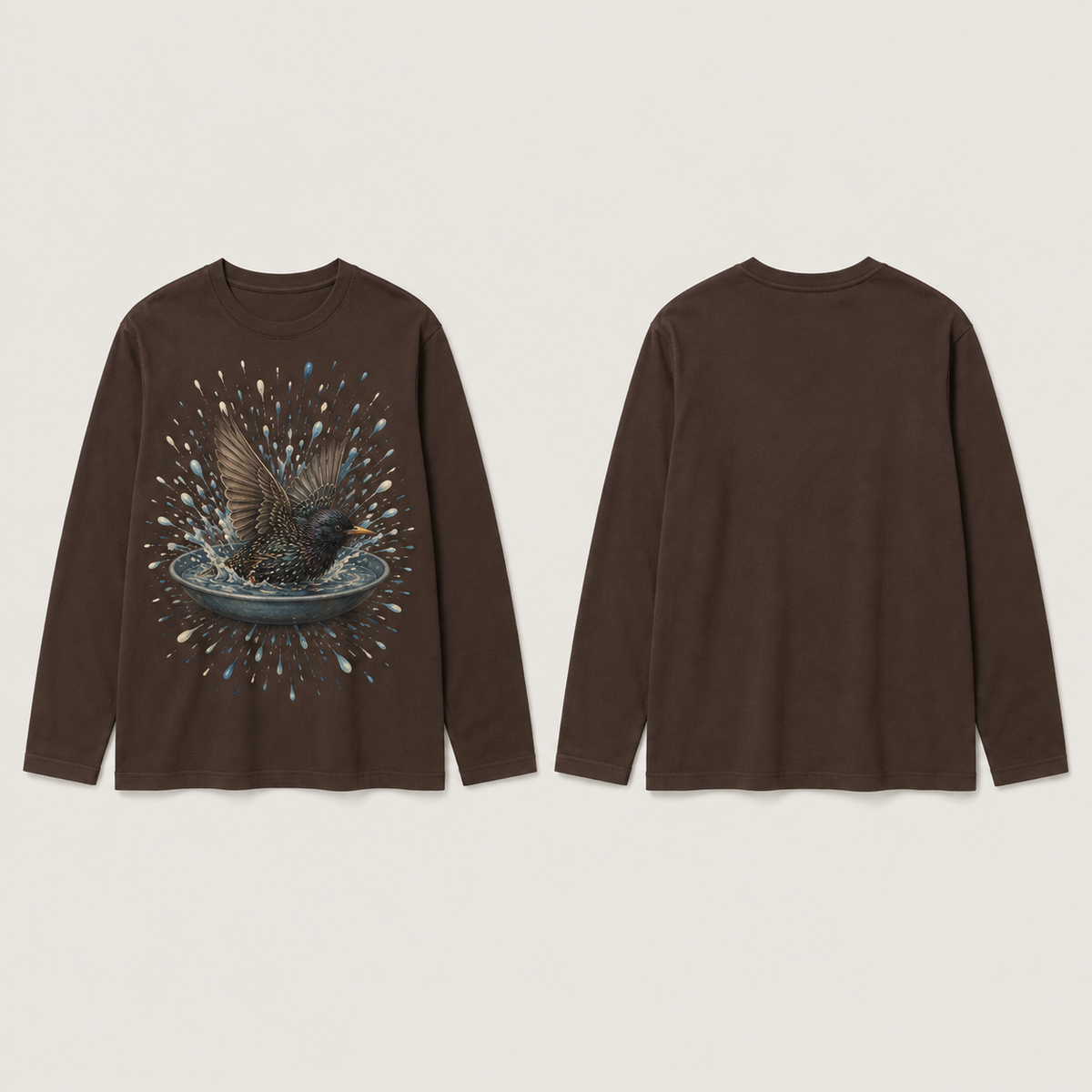 Front and back of a deep-cocoa long-sleeve tee with one starling bathing in a shallow dish inside a radial burst of blue and cream water droplets on the front.