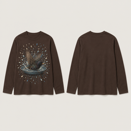 Front and back of a deep-cocoa long-sleeve tee with one starling bathing in a shallow dish inside a radial burst of blue and cream water droplets on the front.