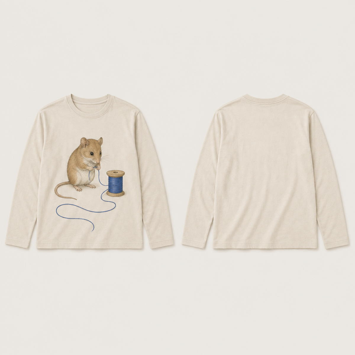 Front and back of an oat long-sleeve tee; a russet mouse holds blue thread beside a wooden spool on the front, with the loose thread curving below and the back plain.
