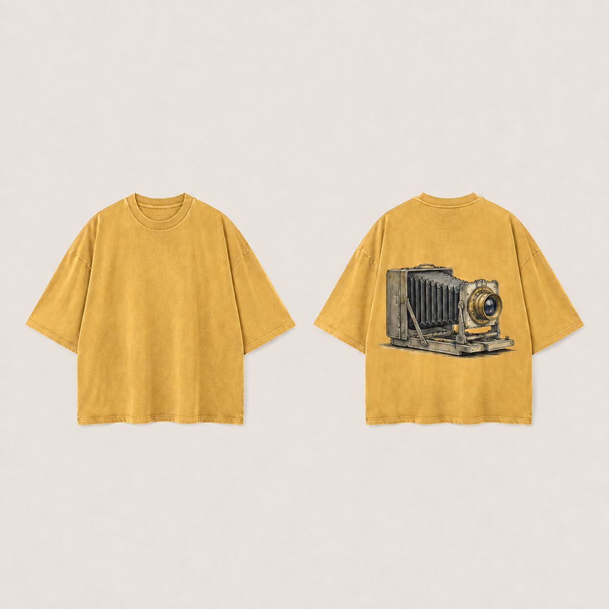 Front and back of a faded marigold oversized tee, with an unlettered folding bellows camera illustration on the back.