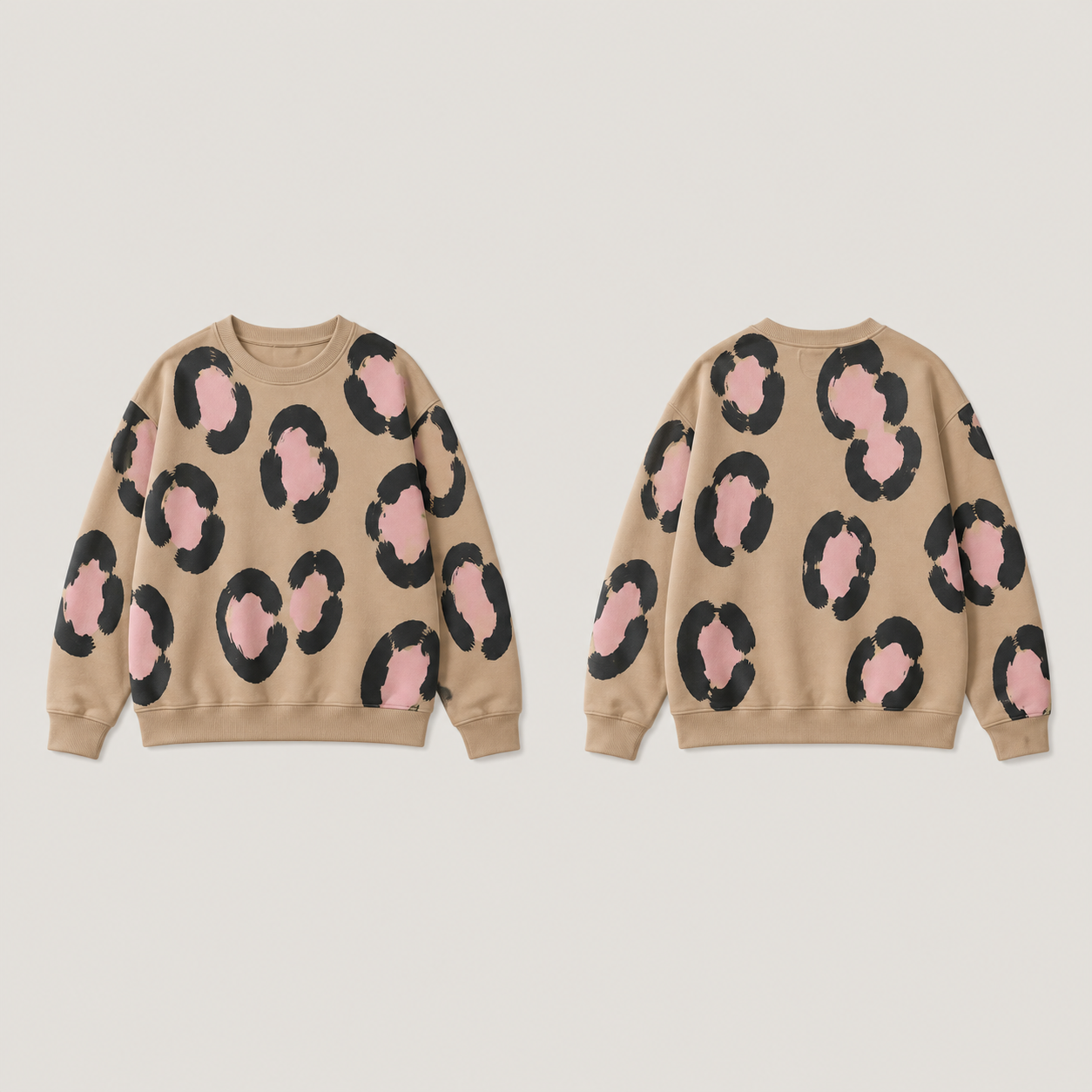 Front and back of a warm-tan crewneck with large broken ink rosettes and pale-pink centers, with plain tan ribs.