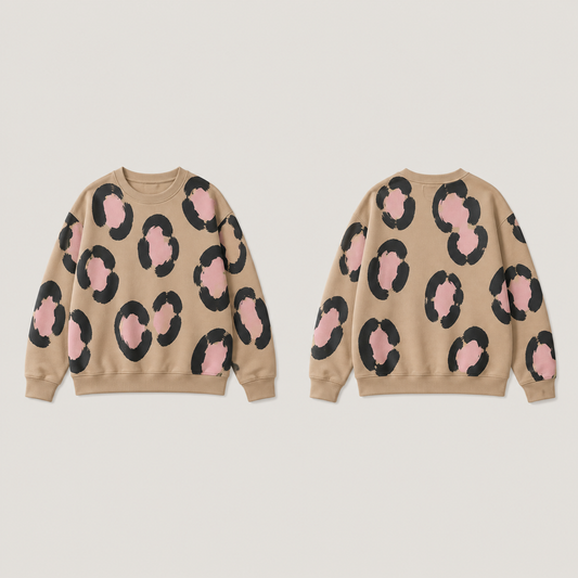 Front and back of a warm-tan crewneck with large broken ink rosettes and pale-pink centers, with plain tan ribs.