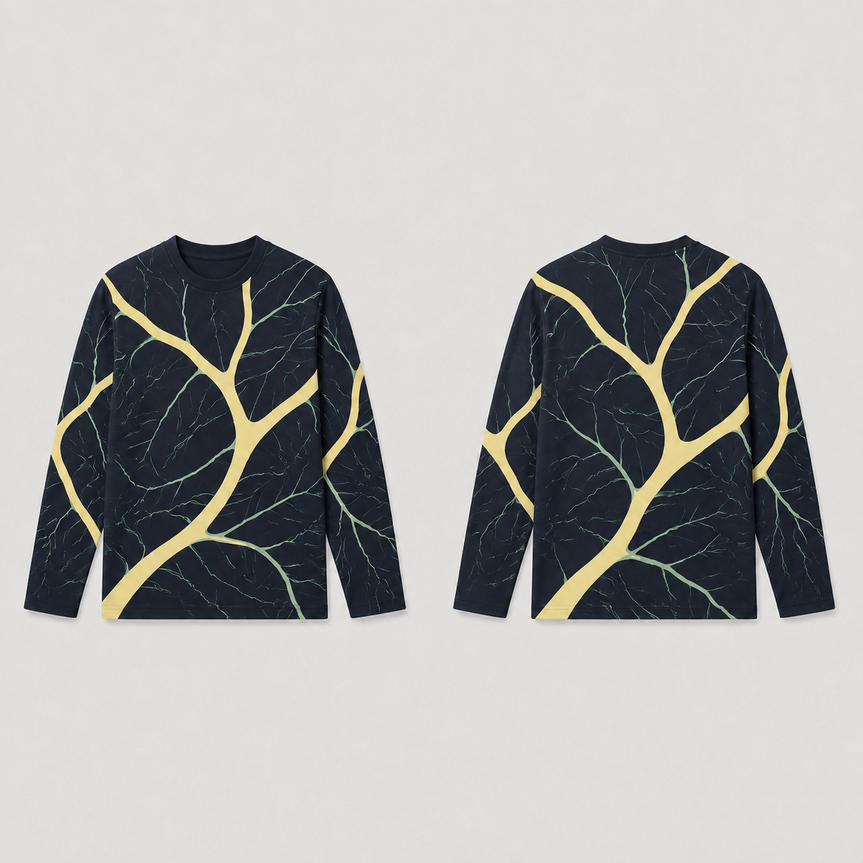 Front and back of an ink long-sleeve tee with curving butter-colored branches and finer celadon veins.