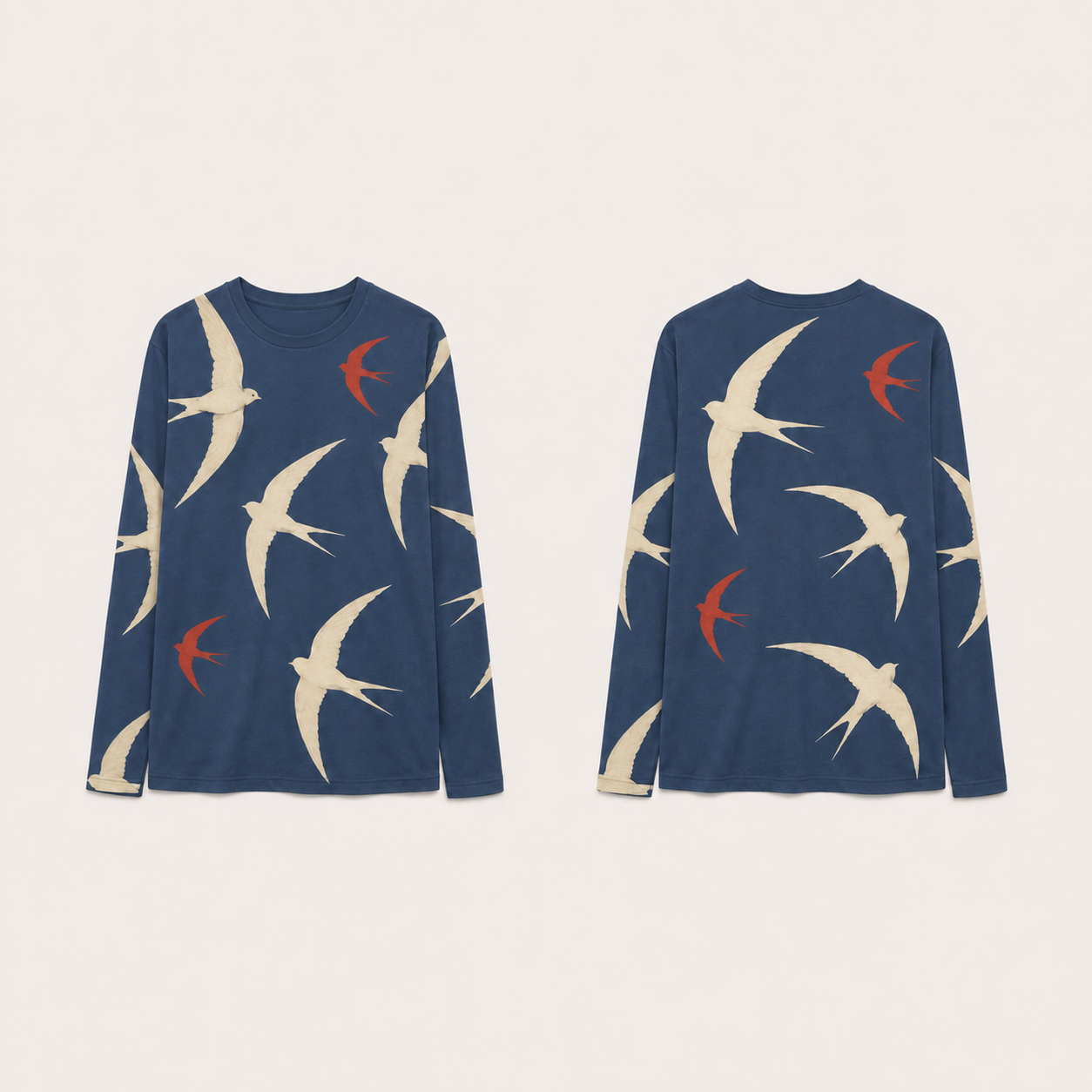 Dusk Blue long-sleeve tee covered in large cream fork-tailed birds and smaller vermilion birds in flight.