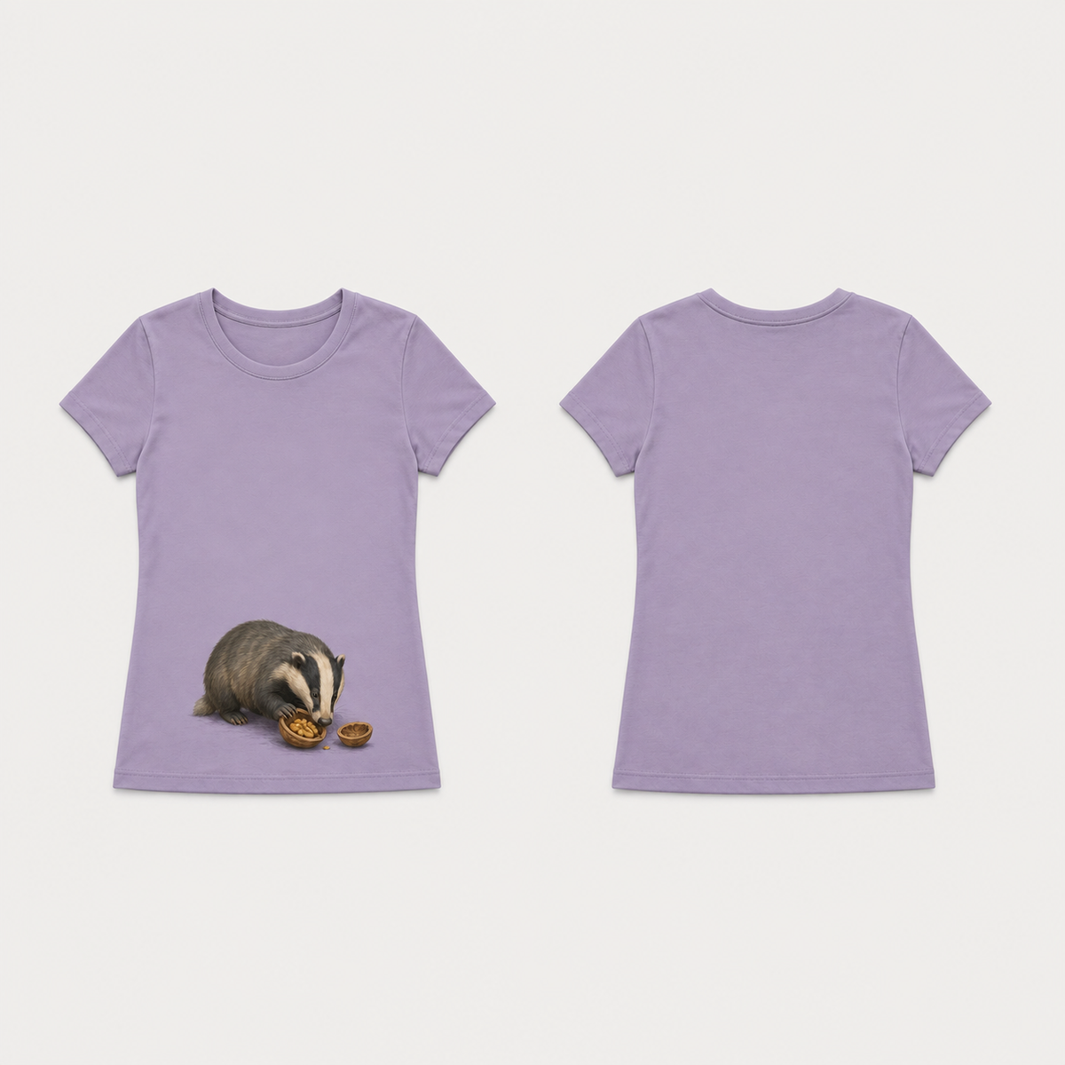 Dusty lavender fitted tee with a badger investigating a walnut half low on the front, beside a separate empty shell; plain back.