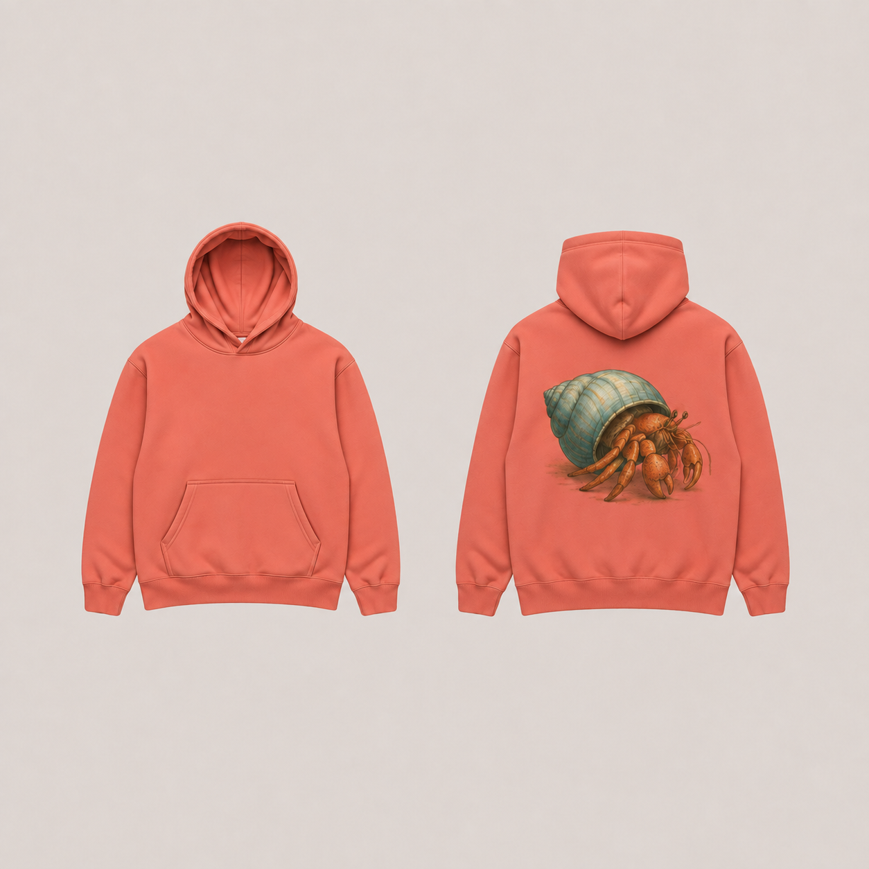 Front and back of a dusty coral pullover hoodie with a hermit crab emerging from a blue-green spiral shell on the back.