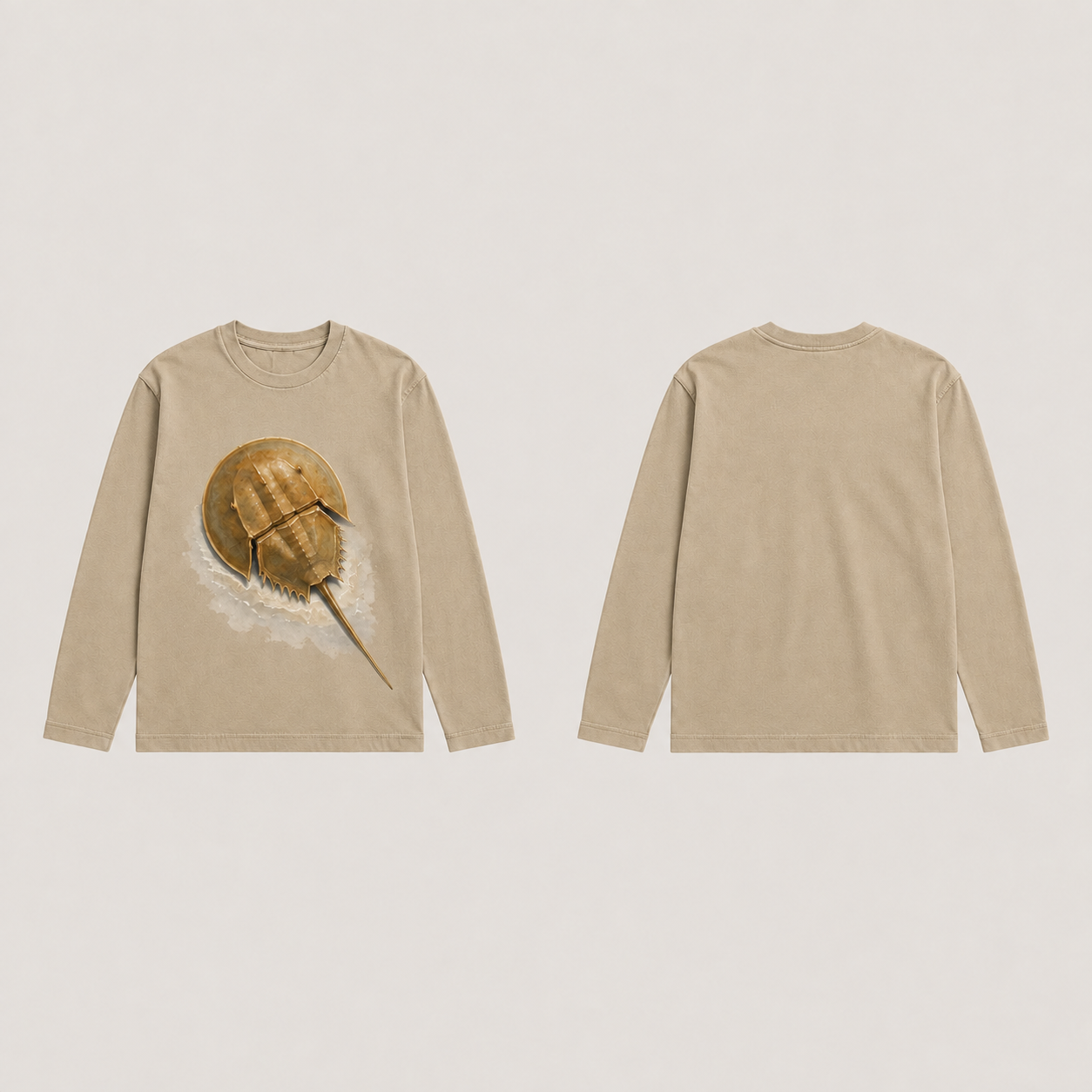 Front and back of a warm-sand long-sleeve tee with an ochre horseshoe crab and pale water wash on the front and a plain back.