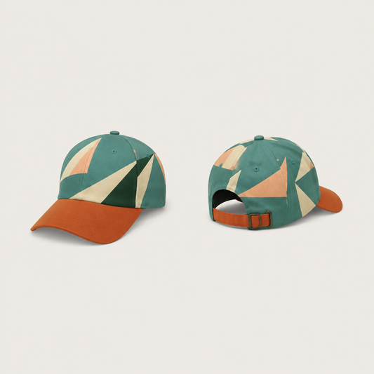 Front and rear views of a sea-green cap with large cream, peach and dark-green sail-like shapes across the crown, a burnt-orange peak and matching adjustable strap.