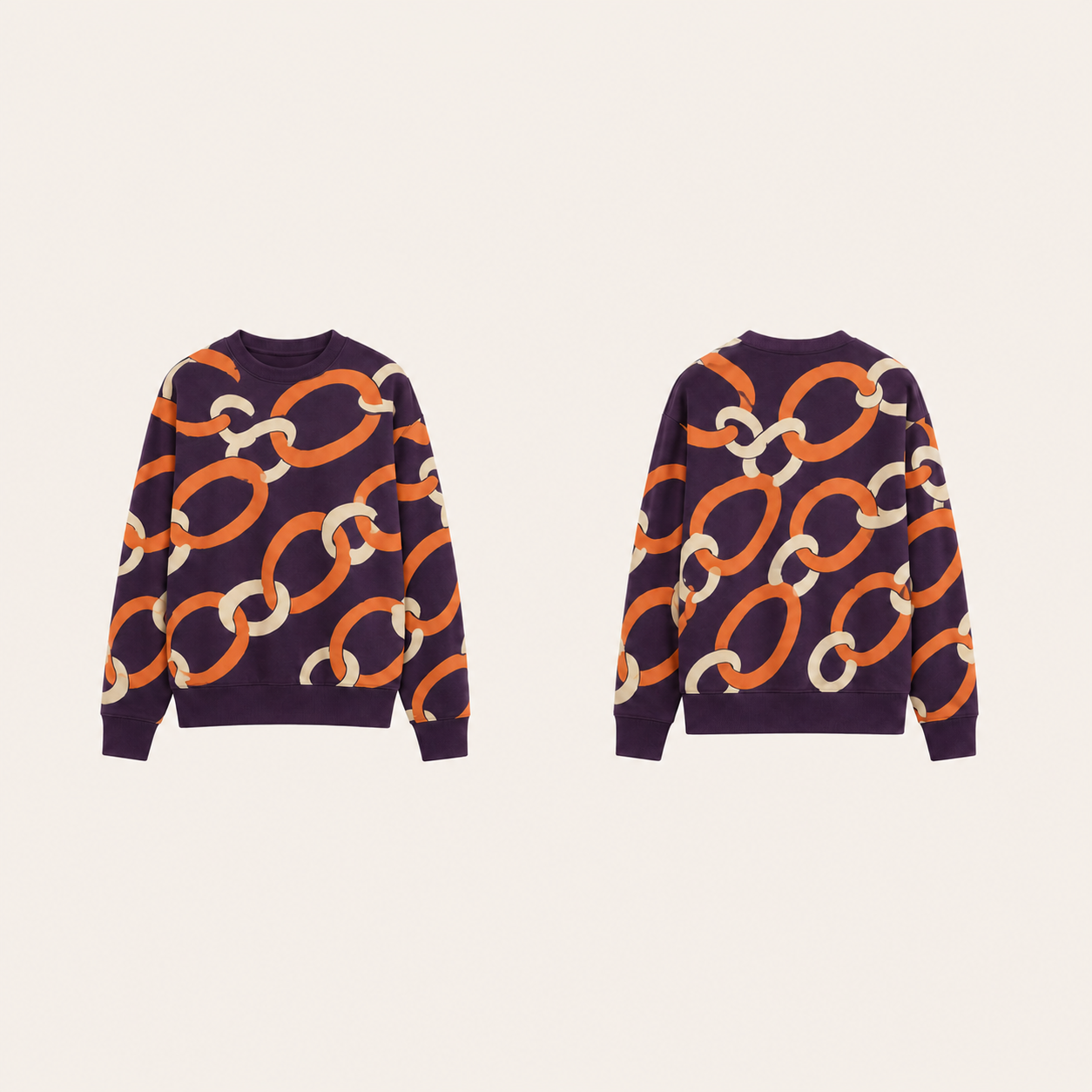 Aubergine crewneck with oversized persimmon and cream linked-ring ornament across front, back and sleeves.