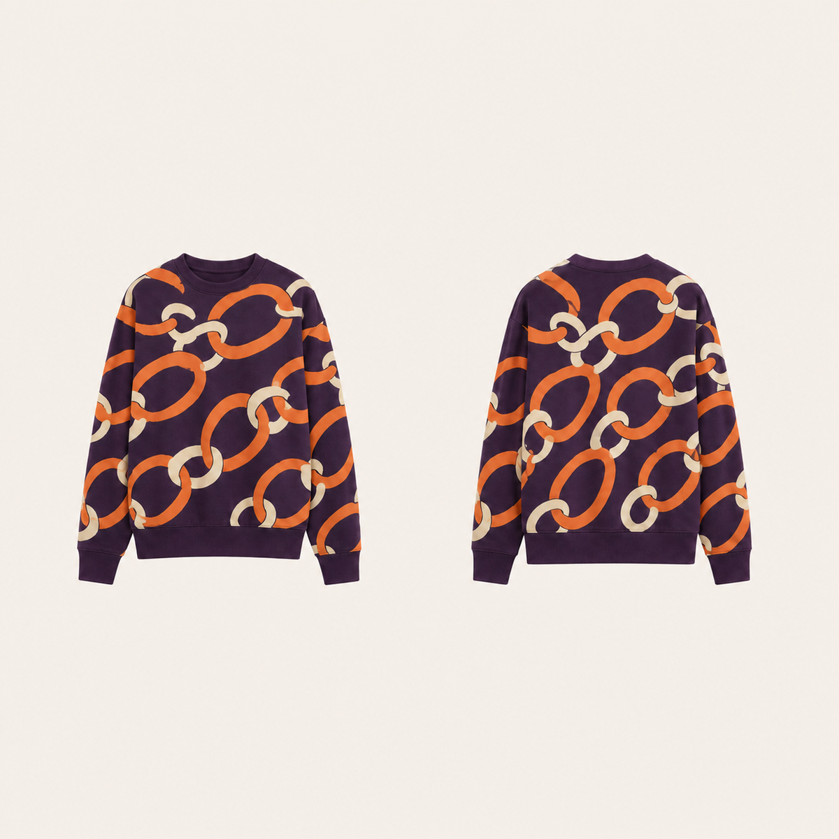 Aubergine crewneck with oversized persimmon and cream linked-ring ornament across front, back and sleeves.