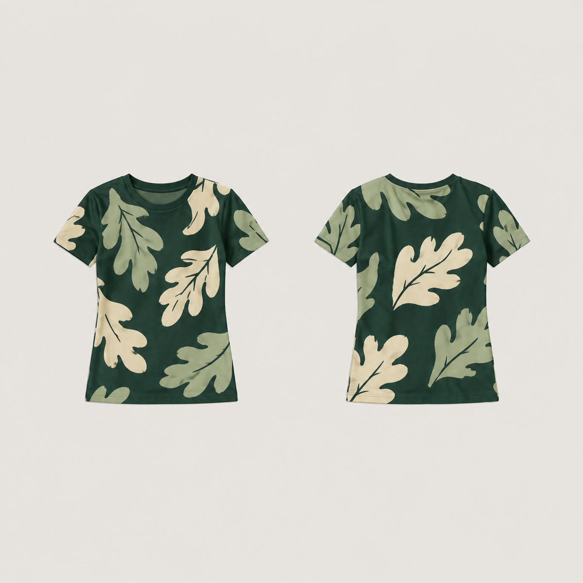 Front and back of a bottle-green fitted tee covered with large irregular cream and muted-mint leaves, with a plain green neckline.