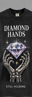 Diamond Hands graphic tee design detail: a diamond held by skeletal hands, with the words STILL HOLDING.