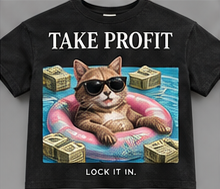 Lock It In: black tee with a cat floating comfortably through banknotes.