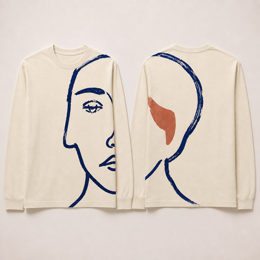 Front and back of a cream long-sleeve tee with one enlarged partial ink portrait continuing around the left side and shoulder, with a rust accent behind.