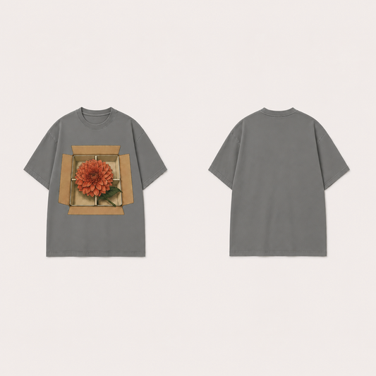 Front and back of a Blank Profile Mineral Gray oversized tee, with one coral dahlia across the compartments of an open ochre box on the front and a plain back.