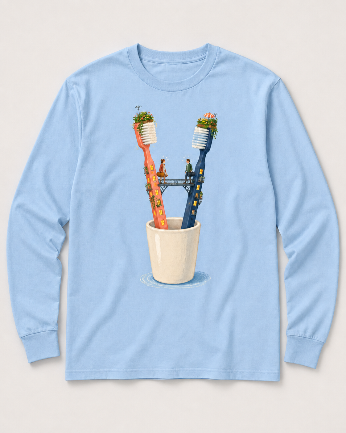 Pale-blue long-sleeve tee design with two toothbrush apartment towers, a bridge, and two people above a bathroom cup.